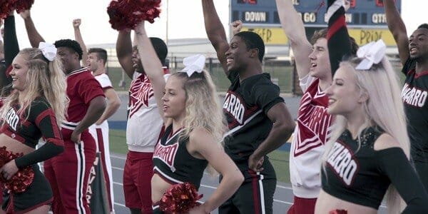 Cheerleaders doing a routine in Cheer