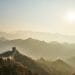 Great wall of China with sun in the sky and foggy haze